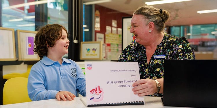 stanmore student and teacher sitting in the library