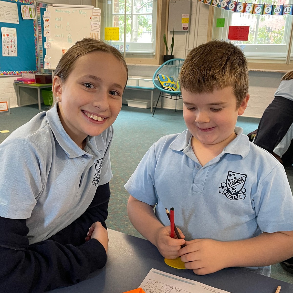 students celebrating simultaneous storytime with their buddies in the library