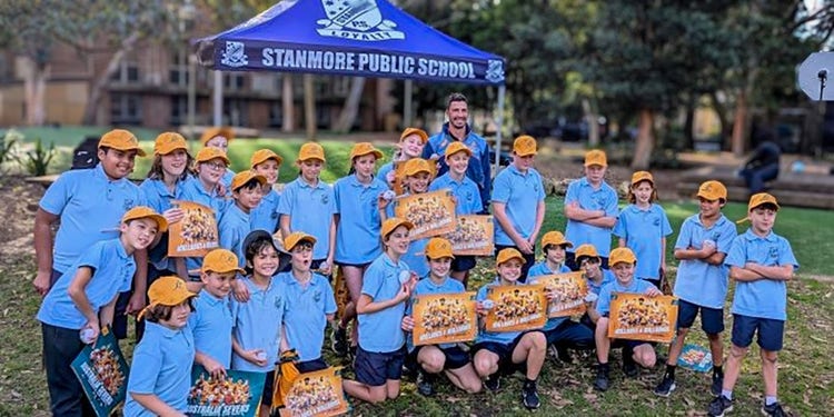 Jake Gordon surounded by students