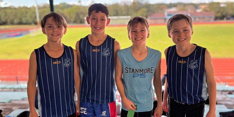 four students at the athletics ground