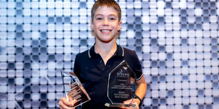 photo of lucas holding diving awards