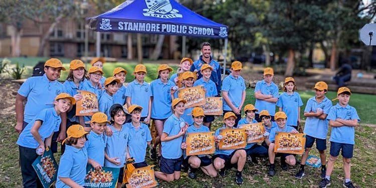 Jake Gordon surounded by students