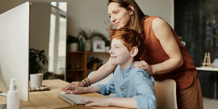 Boy and parent on computer