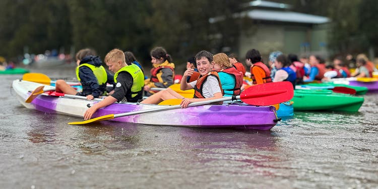 students in kayaks