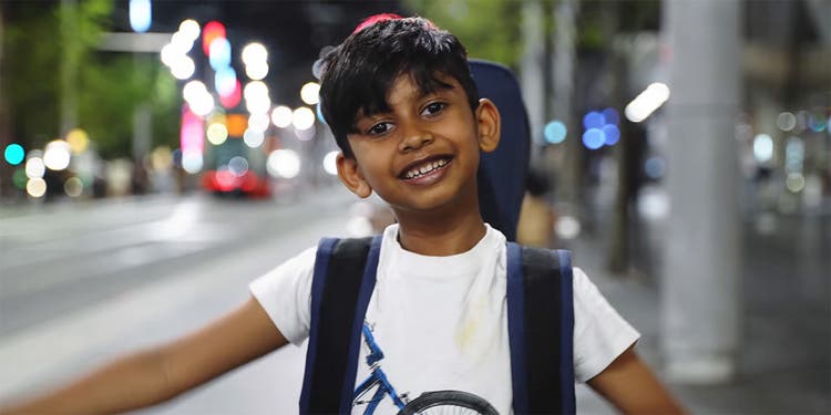 photo of a young student on a sydney street at night with streetlights