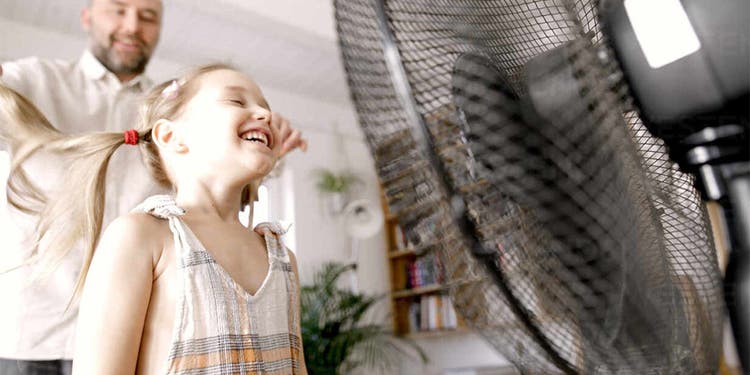 Girl in front of fan