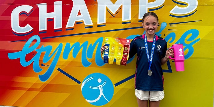 student holding awards at event