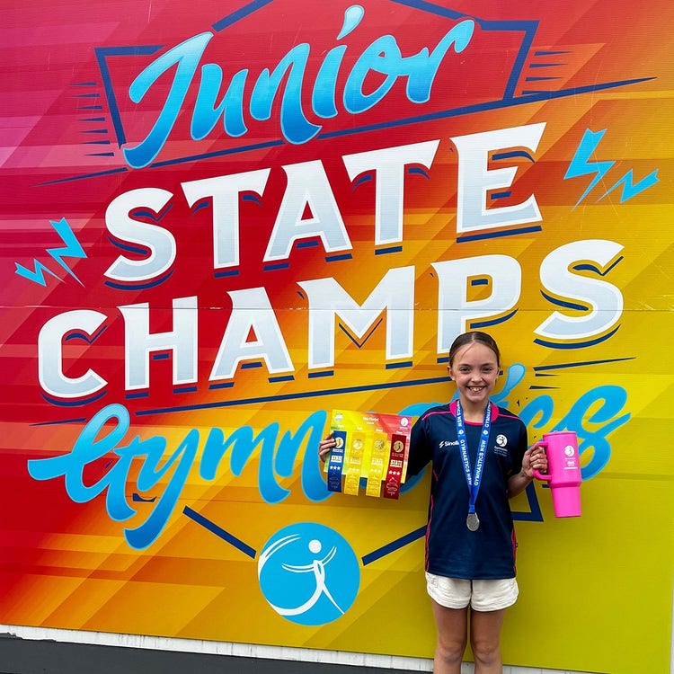 student holding awards at event