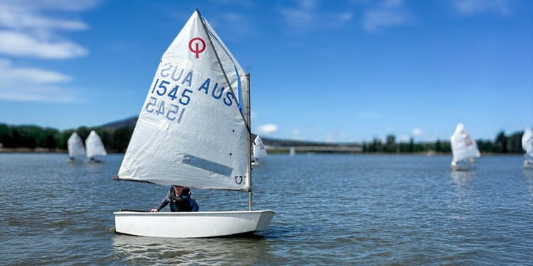 photo of student in yacht on lake