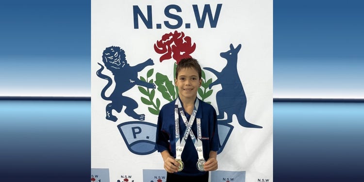 student lucas Hafford-Deboer holding diving medals