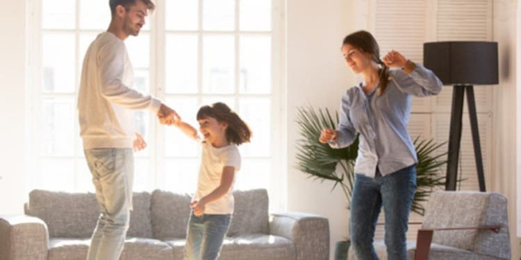 Family dancing around living room