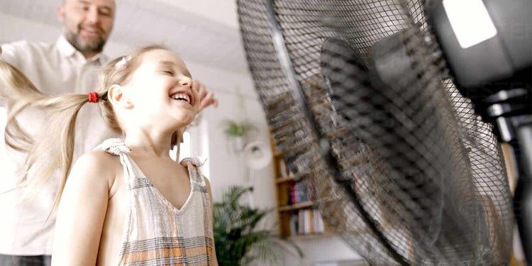 Girl in front of fan