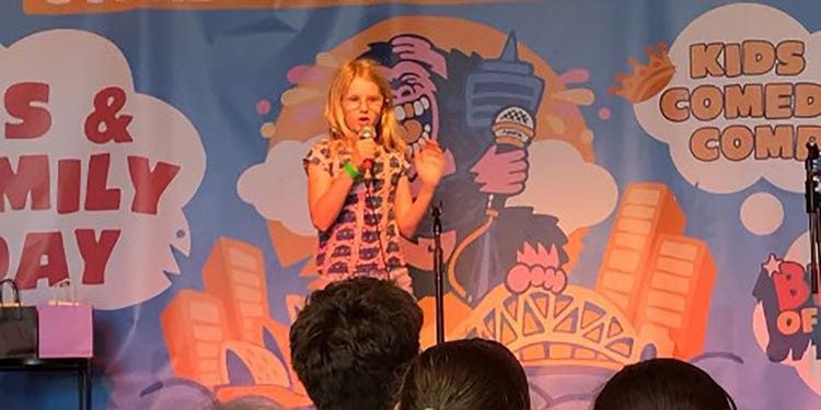 Photo of emily martin performing her comedy standup routine
