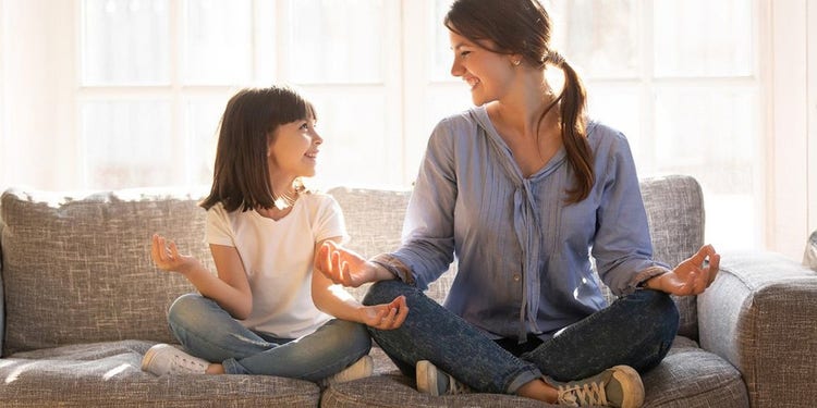 mother and daughter meditating