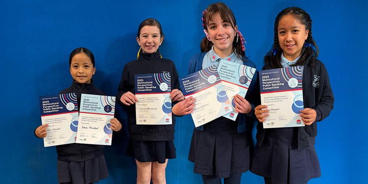 two students holding certificates