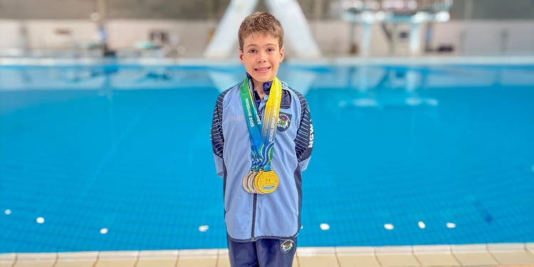 Lucas standing in front of a pool