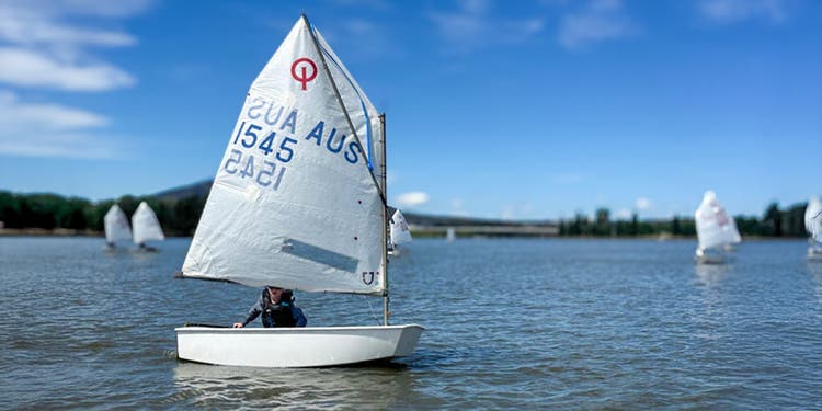photo of student in yacht on lake
