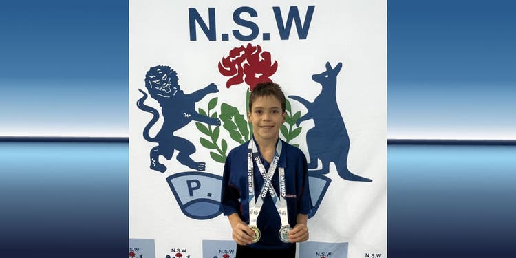 student lucas Hafford-Deboer holding diving medals