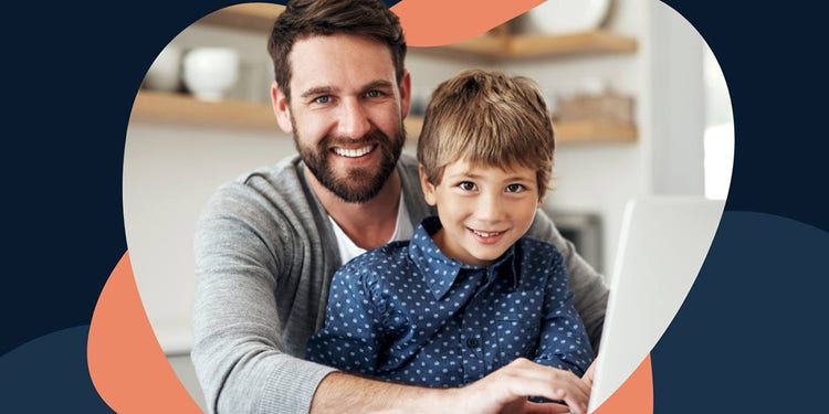 man and boy sitting at a laptop